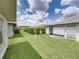 A partially-obstructed view of the home's backyard space, showing the grassy yard and screened-in porch at 4926 Pleasant Hollow Trl, Lakeland, FL 33811