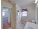 A bright bathroom is located just off the bedroom and features a single sink and a window at 4926 Pleasant Hollow Trl, Lakeland, FL 33811