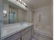 Bright bathroom with white vanity, large mirror, and shower stall, showcasing a clean and functional design at 4926 Pleasant Hollow Trl, Lakeland, FL 33811