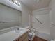 Bathroom featuring accessible tub, shower, and wood look flooring at 4926 Pleasant Hollow Trl, Lakeland, FL 33811