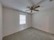 A comfortable bedroom with neutral carpeting, a window with blinds, and a modern ceiling fan at 4926 Pleasant Hollow Trl, Lakeland, FL 33811
