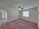 A serene bedroom features soft pink carpeting and a ceiling fan with an integrated lighting fixture at 4926 Pleasant Hollow Trl, Lakeland, FL 33811