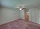 Comfortable bedroom with carpet flooring, fan, and natural light, offering a relaxing retreat at 4926 Pleasant Hollow Trl, Lakeland, FL 33811