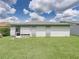 Rear exterior showcasing a well-maintained lawn and a screened porch at 4926 Pleasant Hollow Trl, Lakeland, FL 33811