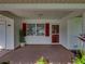 Inviting front porch with vibrant plants, red shutters, and a well-maintained entrance at 4926 Pleasant Hollow Trl, Lakeland, FL 33811