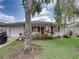 Charming home exterior with lush landscaping, red shutters, and well-maintained lawn at 4926 Pleasant Hollow Trl, Lakeland, FL 33811