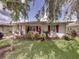 Charming home exterior featuring lush landscaping, vibrant plants, and a well-manicured lawn at 4926 Pleasant Hollow Trl, Lakeland, FL 33811