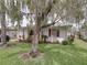 Charming home featuring a well-manicured front lawn and mature landscaping at 4926 Pleasant Hollow Trl, Lakeland, FL 33811
