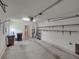 Spacious garage featuring an unfinished floor, white walls, shelving, and plenty of room for vehicles and storage at 4926 Pleasant Hollow Trl, Lakeland, FL 33811