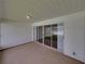 A sunroom/lanai space featuring sliding glass doors and a beige carpet at 4926 Pleasant Hollow Trl, Lakeland, FL 33811