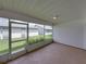The sunroom/lanai features white walls, beige carpeting, and a view of the home's grassy, fenced-in yard at 4926 Pleasant Hollow Trl, Lakeland, FL 33811