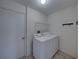 Laundry room featuring machines, access door, and overhead shelving at 4926 Pleasant Hollow Trl, Lakeland, FL 33811
