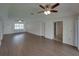 Bright living room with wood-style flooring and ceiling fans, offering a comfortable and inviting space at 4926 Pleasant Hollow Trl, Lakeland, FL 33811