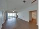 Open-concept living room featuring laminate floors and access to a screened patio at 4926 Pleasant Hollow Trl, Lakeland, FL 33811