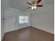 Bright living room featuring laminate floors, a front door, and a ceiling fan at 4926 Pleasant Hollow Trl, Lakeland, FL 33811