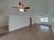 Spacious living room featuring laminate floors, ceiling fans, and natural light; ready for new owners at 4926 Pleasant Hollow Trl, Lakeland, FL 33811