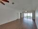 Spacious living room with laminate floors, ceiling fans, and access to outdoor patio at 4926 Pleasant Hollow Trl, Lakeland, FL 33811