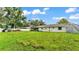 Spacious backyard featuring a large grassy area, white fence, and a playset at 5316 Forestbrook E Dr, Lakeland, FL 33811