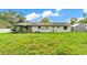 Expansive backyard with lush green lawn, exterior house view, and ample space for outdoor activities at 5316 Forestbrook E Dr, Lakeland, FL 33811