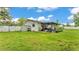 Lush backyard with a screen-enclosed porch area, storage shed, and well-maintained lawn at 5316 Forestbrook E Dr, Lakeland, FL 33811