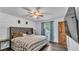 Bedroom with wood-look flooring, shiplap accent wall, a ceiling fan, and a tufted headboard at 5316 Forestbrook E Dr, Lakeland, FL 33811