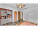 Bedroom featuring wood-look floors, closet, and an archway creating a cheerful space at 5316 Forestbrook E Dr, Lakeland, FL 33811
