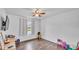 Spacious bedroom with stylish wood-look floors, ceiling fan, and bright window, creating a comfortable and inviting retreat at 5316 Forestbrook E Dr, Lakeland, FL 33811