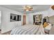 Bedroom with wood-look flooring, a closet with open doors, and a ceiling fan at 5316 Forestbrook E Dr, Lakeland, FL 33811
