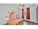 Bright bedroom featuring modern ceiling fan, wood-look floors, and a whimsical sun mural, creating a cheerful space at 5316 Forestbrook E Dr, Lakeland, FL 33811