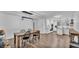 Open-concept dining area with wooden table, black chairs, and modern light fixture at 5316 Forestbrook E Dr, Lakeland, FL 33811