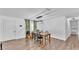 Dining room with wood-look flooring, a modern light fixture, table, and chairs at 5316 Forestbrook E Dr, Lakeland, FL 33811