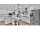 Beautiful updated kitchen with stainless steel appliances, white cabinets, and rustic floating shelves at 5316 Forestbrook E Dr, Lakeland, FL 33811
