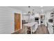 Modern kitchen featuring white cabinets, a quartz island, and stainless steel appliances at 5316 Forestbrook E Dr, Lakeland, FL 33811