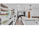 Modern kitchen with white cabinets, stainless steel appliances, and stylish open shelves at 5316 Forestbrook E Dr, Lakeland, FL 33811