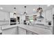 Bright kitchen featuring white cabinets, quartz countertops, and stainless steel appliances at 5316 Forestbrook E Dr, Lakeland, FL 33811