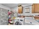 Laundry room with modern washer and dryer, shelving and storage space, offering functionality and convenience at 5316 Forestbrook E Dr, Lakeland, FL 33811