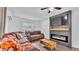 Cozy living room featuring shiplap walls, a brown leather sectional sofa, and an electric fireplace at 5316 Forestbrook E Dr, Lakeland, FL 33811