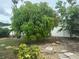 Lush backyard featuring mature trees and a well-maintained lawn, creating a serene and private outdoor oasis at 5480 Summerland Hills Dr, Lakeland, FL 33812