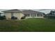 Expansive backyard showcasing a screened-in patio and lush green grass at 5480 Summerland Hills Dr, Lakeland, FL 33812