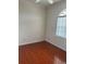Cozy bedroom with a large arched window, laminate flooring, and ample natural light at 5480 Summerland Hills Dr, Lakeland, FL 33812