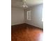 Simple bedroom featuring laminate floors, a ceiling fan, and two windows for ample natural light at 5480 Summerland Hills Dr, Lakeland, FL 33812