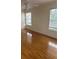 Spacious bedroom showcasing laminate floors, two large windows, and ample natural light at 5480 Summerland Hills Dr, Lakeland, FL 33812