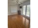 Bright bedroom showcasing laminate flooring, a ceiling fan, and a sliding glass door at 5480 Summerland Hills Dr, Lakeland, FL 33812