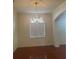 Elegant dining area with hardwood floors, decorative ceiling, and chandelier for sophisticated dining at 5480 Summerland Hills Dr, Lakeland, FL 33812