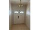 Inviting entryway features a double front door with half-round windows and a classic overhead light fixture at 5480 Summerland Hills Dr, Lakeland, FL 33812