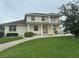 Inviting two-story home with a charming front porch, white railings, and well-maintained landscaping at 5480 Summerland Hills Dr, Lakeland, FL 33812