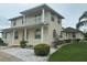 Elegant two-story home with a well-manicured lawn, beautiful landscaping, and welcoming front porch at 5480 Summerland Hills Dr, Lakeland, FL 33812