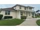 Charming two-story home featuring front porch, balcony, manicured lawn, and lovely landscaping at 5480 Summerland Hills Dr, Lakeland, FL 33812