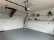 Spacious garage featuring epoxy flooring, water heater, storage shelves, and convenient garage door opener at 5480 Summerland Hills Dr, Lakeland, FL 33812