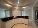 Well-equipped kitchen featuring an eat-in bar, white cabinetry, and modern tile floors at 5480 Summerland Hills Dr, Lakeland, FL 33812